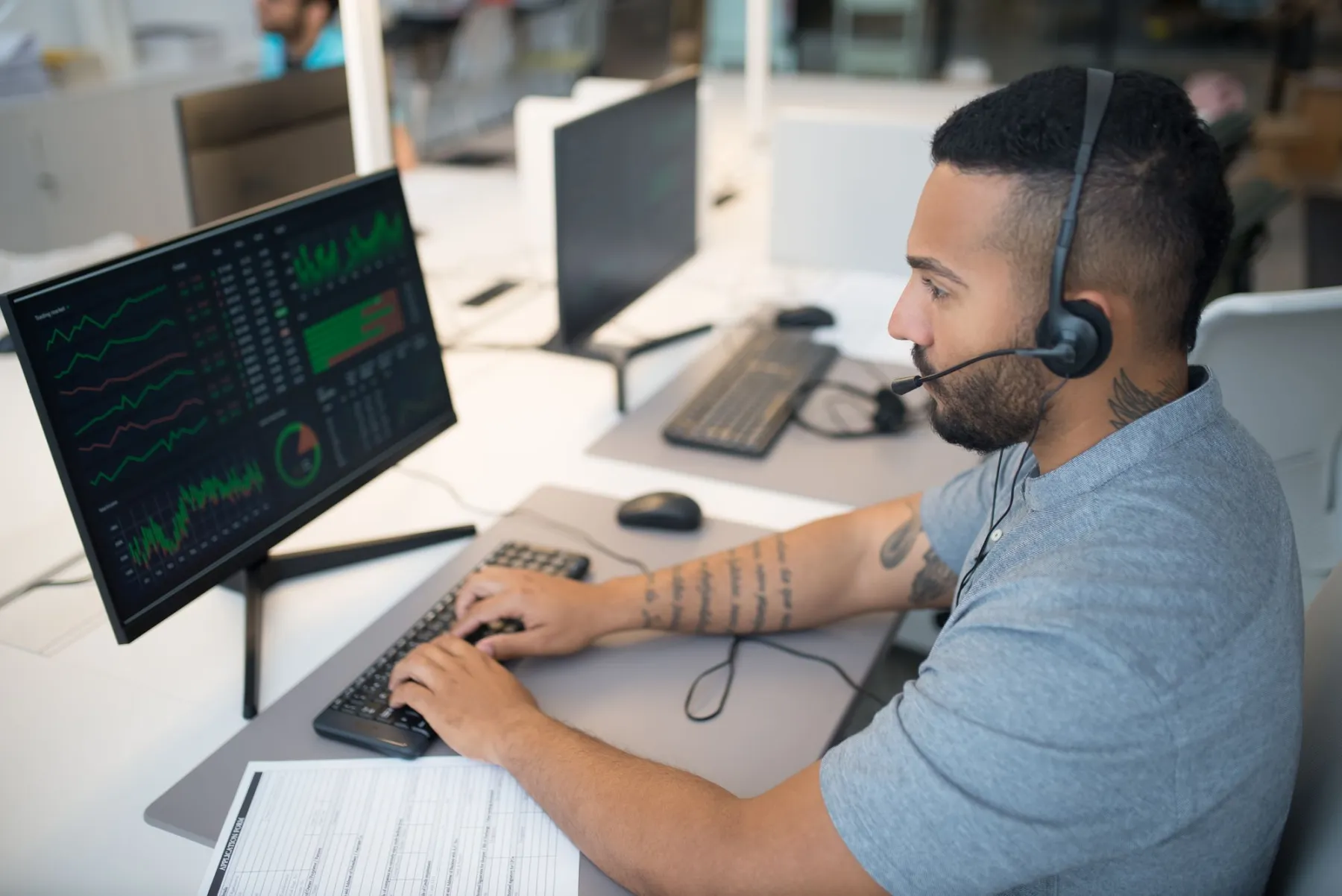 A dispatcher with a headset at his desk